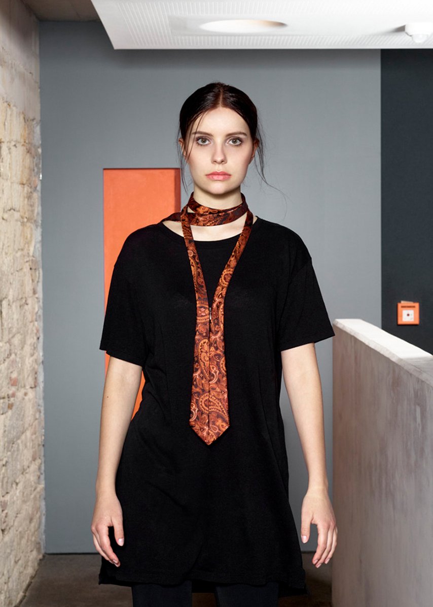 junge Frau trägt orange Krawatte von der Designerin Carmen Hauser.
